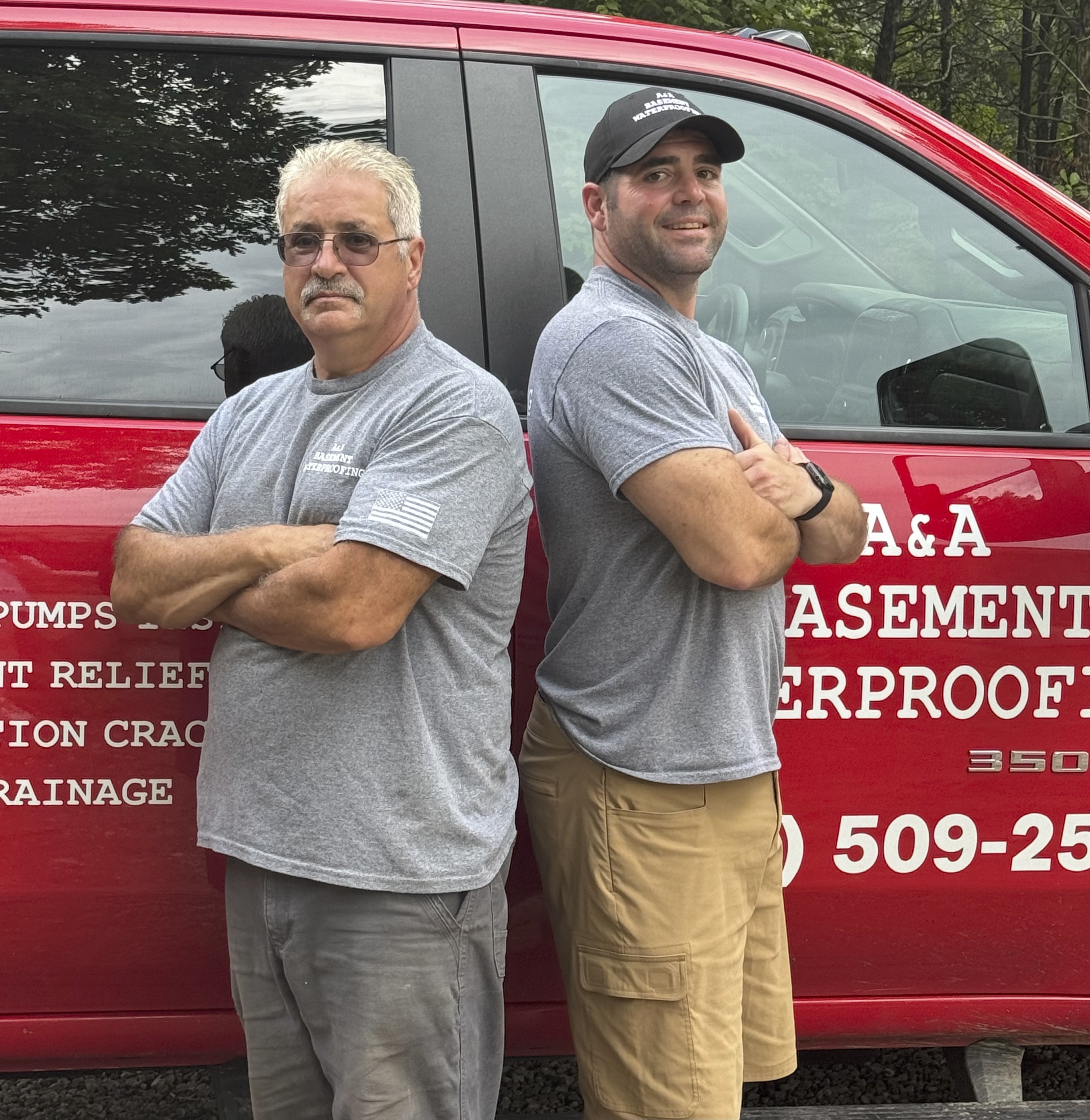 Alan and Alan Clement, father and son owners of A&A Basement Waterproofing, in front of their work truck