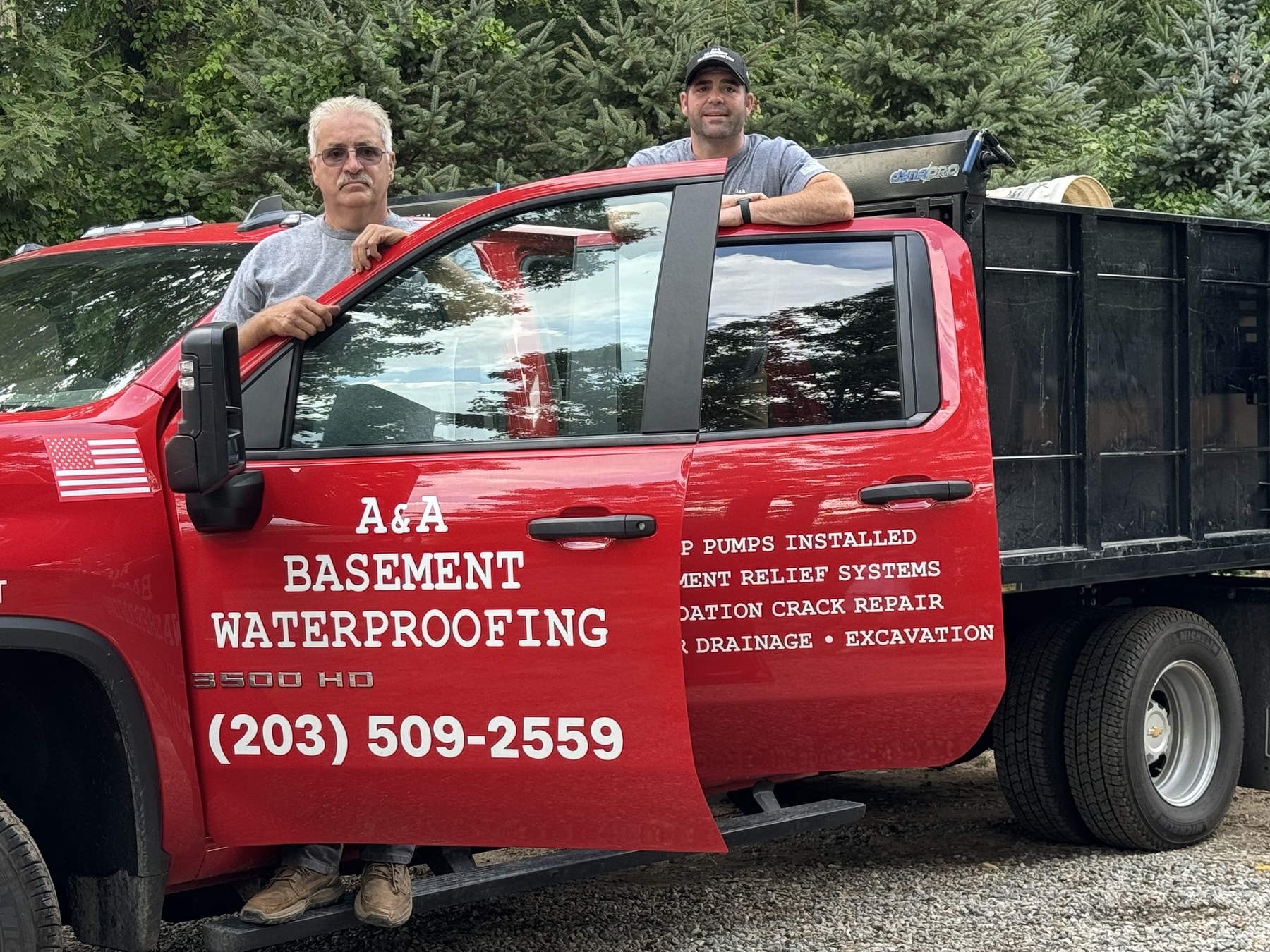 Alan and Alan Clement, father-and-son owners of A&A Basement Waterproofing, with their red A&A Basement Waterproofing 3500 HD truck — Bethany, Connecticut